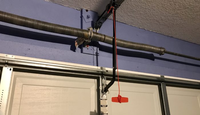 Garage door emergency release red rope for safety reasons while repairing Linear broken motor unit gears