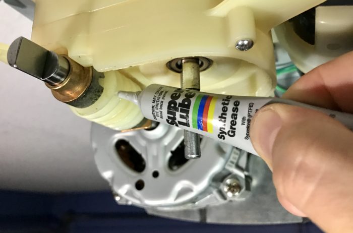 Lubricating Linear garage door opener motor unit gears