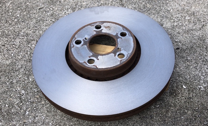 Turn grind machine brake disk rotor to fix runout